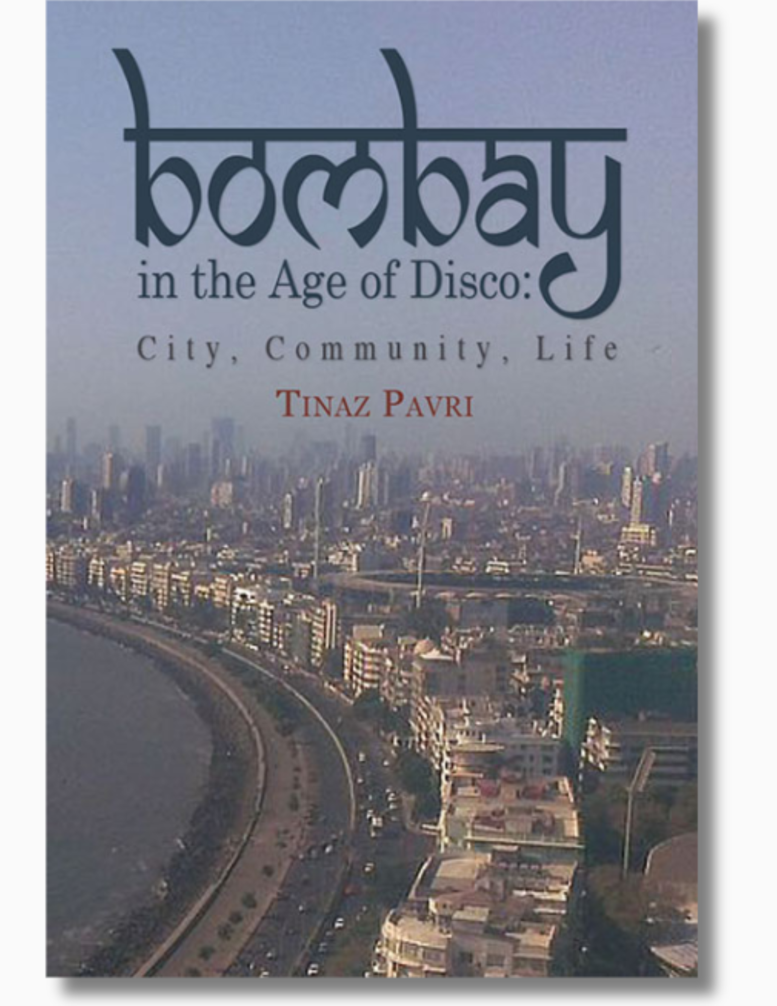 Cover of Bombay in the Age of Disco: City, Community, Life by Tinaz Pavri. The cover features an aerial view of Mumbai’s coastline with dense buildings and a curving waterfront road.